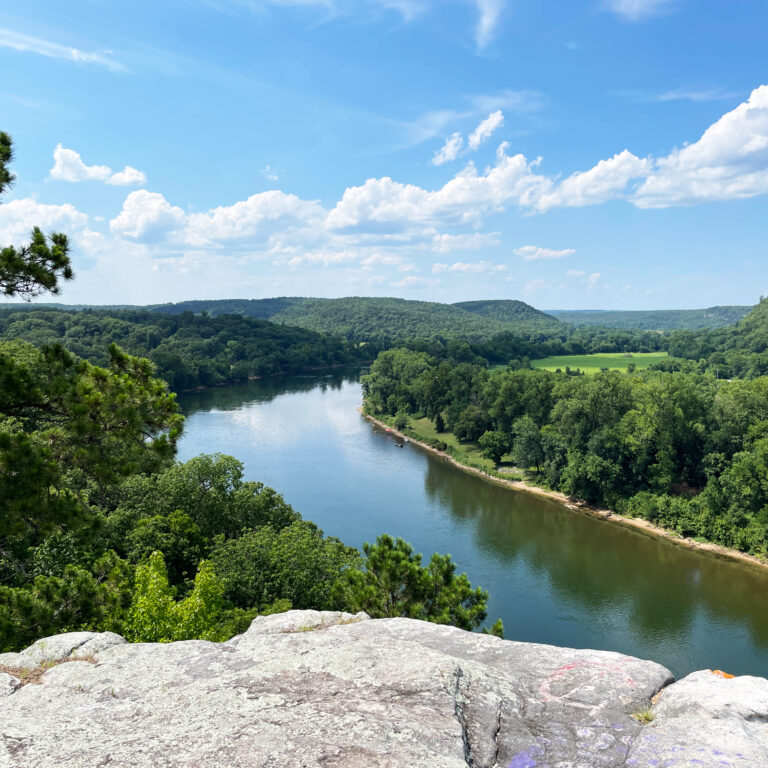 City Rock Bluff in Calico Rock Arkansas overlooking the White River in summer with a blue sky and clouds horizontal