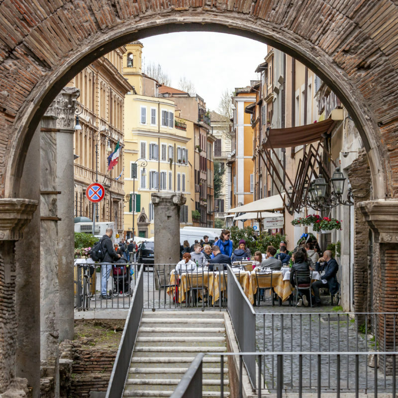 Tourists and locals flock to one of the many restaurants in the Roman Ghetto district. This small neighborhood is delimited by the Tiber River on one side and by Venice Square on the other. While steeped in cultural and religious history, today, this area of Rome, Italy, is filled with quaint restaurants and shops in the old buildings. IMB Photo